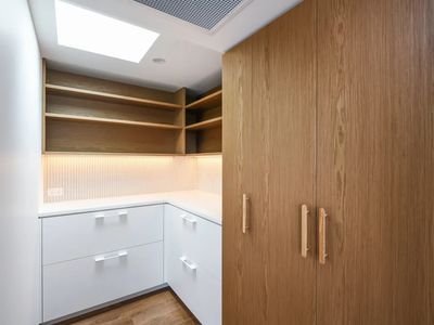 Custom butler's pantry with oak veneer cabinetry and open shelving