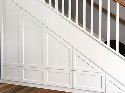 Custom under stair cabinetry with handleless shaker doors